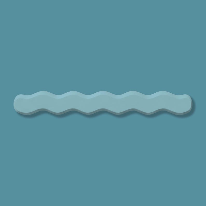May include: A light blue, wavy-shaped decorative object with a shadow, set against a solid teal background. The object has a smooth, matte finish and a symmetrical, undulating design, resembling a stylized wave.