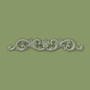 May include: A light grey, symmetrical scrollwork design featuring a central floral motif and swirling leaf patterns. The design is set against a muted green background, creating a classic, elegant aesthetic. This architectural element is suitable for interior design.