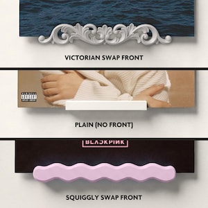 May include: Three different shelf fronts are displayed. The top shelf has a white, ornate Victorian design. The middle shelf is plain white. The bottom shelf has a pink, wavy design with the text "SQUIGGLY SWAP FRONT". The text "BLACKPINK" is also visible.