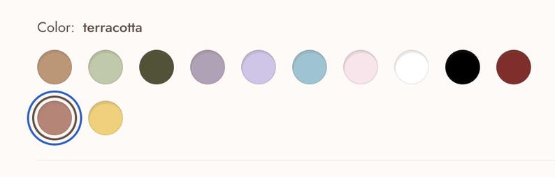 May include: A color palette featuring a series of circular color swatches. The text "Color: terracotta" is above the swatches. The selected color, terracotta, is highlighted with a blue and black outline. Other colors include brown, green, olive, purple, blue, pink, white, black, and maroon.