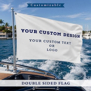 May include: A white rectangular double-sided flag mounted on a silver metal pole attached to a boat railing. The flag features dark blue text that reads CUSTOMIZABLE, YOUR CUSTOM DESIGN, and YOUR CUSTOM TEXT OR LOGO, with a banner at the bottom.