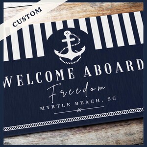 May include: A rectangular doormat featuring a navy blue and white vertical striped top section, a central white anchor graphic, and the text "WELCOME ABOARD", "Freedom", and "MYRTLE BEACH, SC" in white. A white rope border lines the bottom edge.