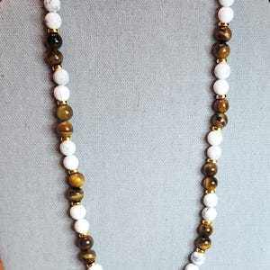 Beautiful Tiger Eye and  Howlight Gemstones with gold plated spacer beads Necklace is .  20" long. With Hinged clasp.