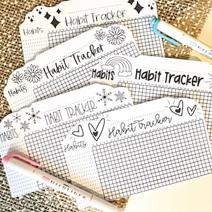 May include: Five black and white habit tracker sheets with different decorative elements. The sheets have a grid pattern and the words "Habit Tracker" and "Habits" are written on each sheet.