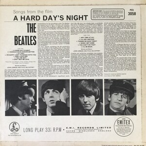 May include: The Beatles' "A Hard Day's Night" album cover features a black and white photo of the band members. The album title is printed in large, bold letters. The back of the album features a description of the album and the songs included.