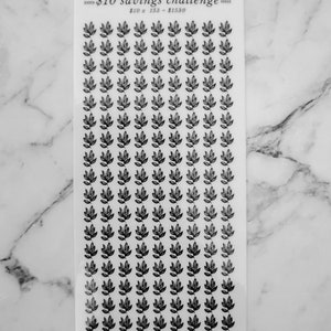 May include: A sheet of clear stickers with black leaf designs. The sheet has the text "&pound;10 savings challenge" and "&pound;10 x 153 = &pound;1530" printed on it. The bottom of the sheet says "trust the process".