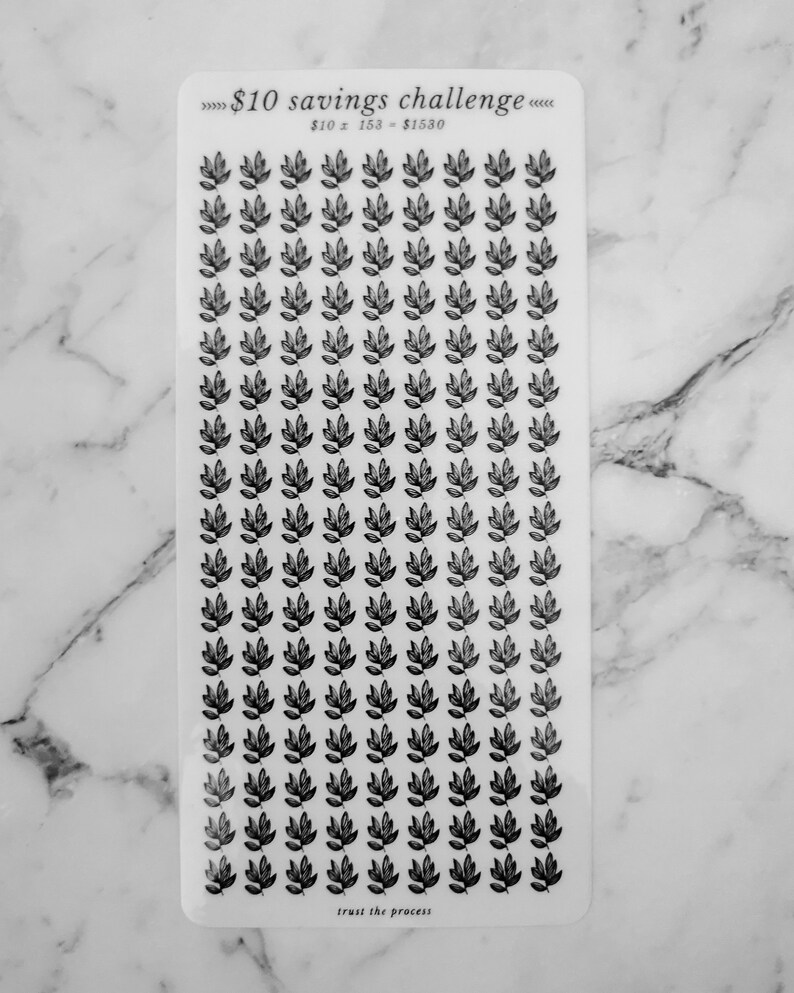 May include: A sheet of clear stickers with black leaf designs. The sheet has the text "&pound;10 savings challenge" and "&pound;10 x 153 = &pound;1530" printed on it. The bottom of the sheet says "trust the process".