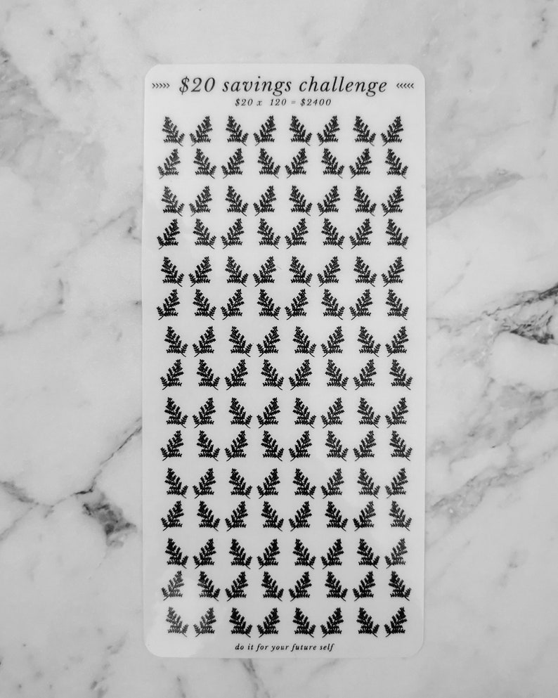 May include: A sheet of clear stickers with black fern leaf designs. The sheet has the text "&pound;20 savings challenge" and "&pound;20 x 120 = &pound;2400" printed on it. The bottom of the sheet has the text "do it for your future self".