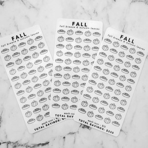 May include: Three sheets of stickers with a fall theme. Each sheet has a repeating pattern of pie and pumpkin icons. The text on the sheets reads "FALL fall breeze & autumn leaves" and "each icon $10 TOTAL SAVINGS: $550".