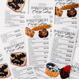 May include: A collection of illustrated bakery items on white cards, including pastries, tarts, and bagels. The cards feature the text "Baked Fresh Every Day" and list various baked goods.