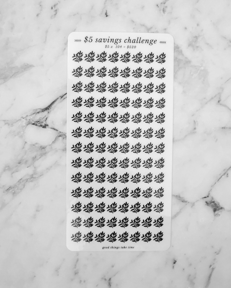 May include: A sheet of clear stickers with black floral designs. The sheet has the text "&pound;5 savings challenge" and "&pound;5 x 104 = &pound;520" printed on it. The bottom of the sheet says "good things take time".