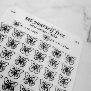 May include: A white sheet with black butterfly stickers and the text "set yourself free" with a calculation of total savings. The text reads "total savings = $675", "$5 x 45 = $225", and "$10 x 45 = $450".