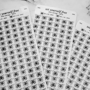 May include: Three sheets of clear sticker paper with black butterfly designs. The sheets have the text "set yourself free" and "first love yourself" printed on them.