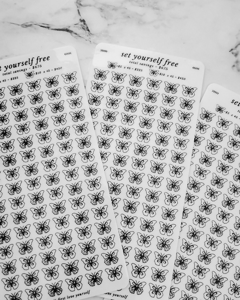 May include: Three sheets of clear sticker paper with black butterfly designs. The sheets have the text "set yourself free" and "first love yourself" printed on them.