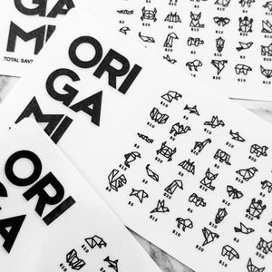 May include: White paper sheets with black origami animal illustrations and the word "ORIGAMI" in bold letters. The sheets feature various origami designs with prices ranging from $5 to $20.