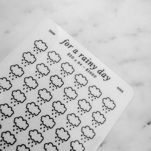 May include: A sheet of clear stickers with a repeating pattern of black and white rain clouds. The text "for a rainy day" is printed at the top of the sheet. The text "$20 x 84 = $1680" is printed below the title.