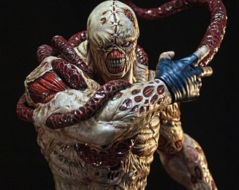 May include: A detailed figurine of a monstrous humanoid figure with exposed muscle tissue and a pale, scarred face. The figure has multiple tentacles and is wearing dark blue trousers and a blue glove. The words "Final Product" are visible at the bottom left.