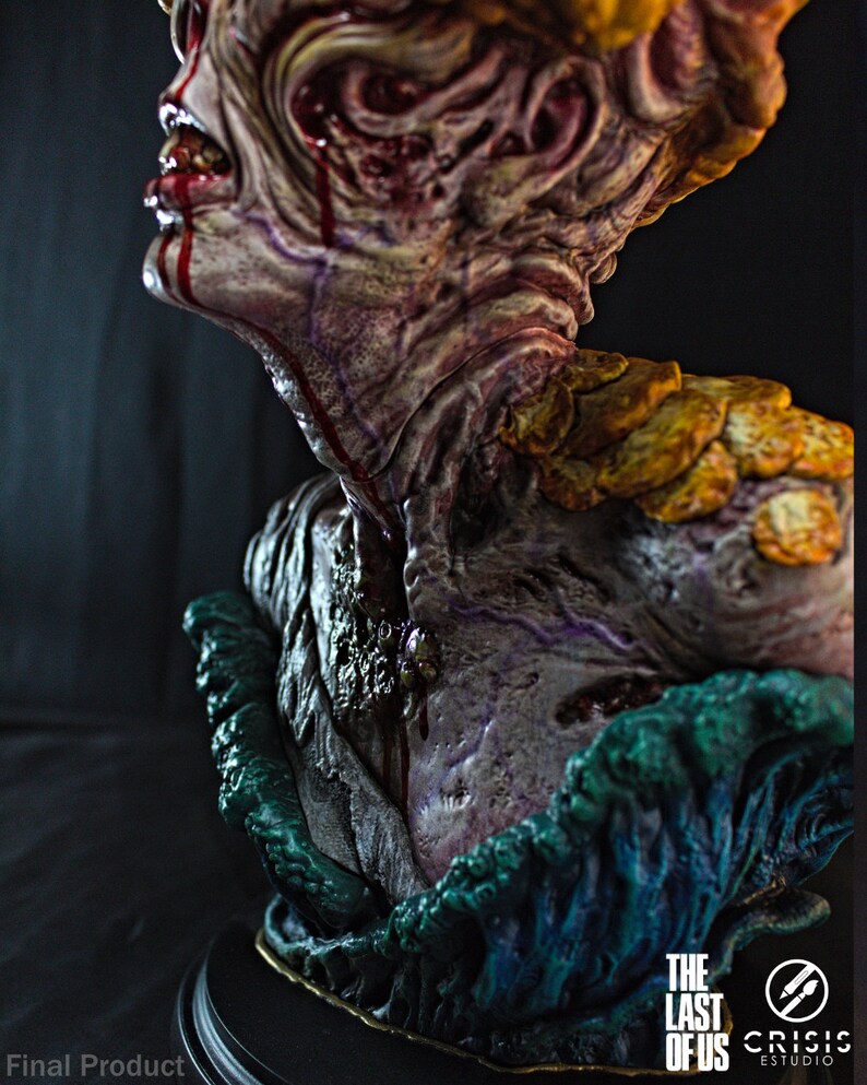 May include: A detailed bust of a creature from "The Last of Us" video game. The sculpture features a grotesque, decaying face with exposed flesh, dripping blood, and fungal growths. The base is dark with the game's logo.