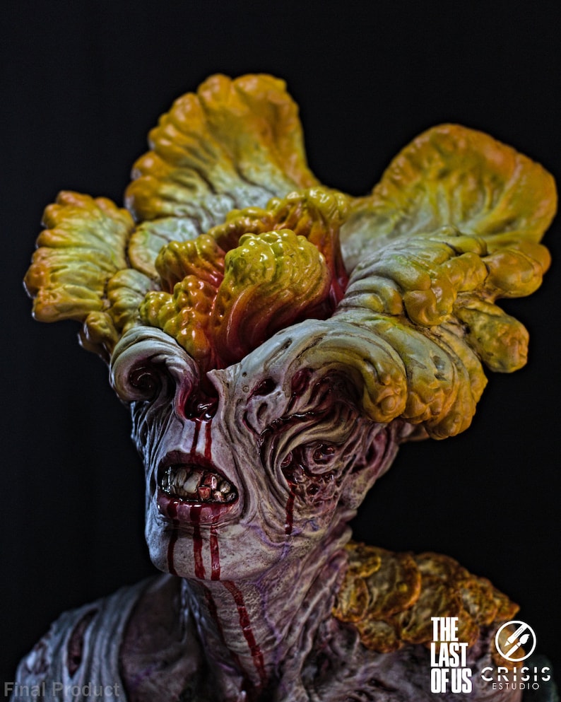 May include: A detailed sculpture of a zombie-like creature from "The Last of Us." The figure has a grotesque appearance with exposed teeth, blood dripping from the mouth and eyes, and a large, mushroom-like growth on its head. The sculpture is set against a dark background.
