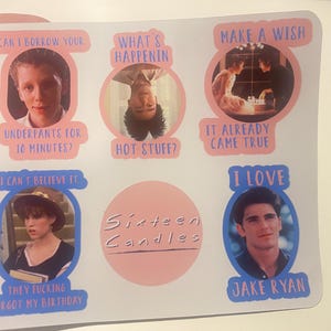 May include: A sticker sheet featuring images and quotes from the movie "Sixteen Candles." The sticker sheet has six circular images with quotes like "Can I borrow your underpants for 10 minutes?" and "I love Jake Ryan."