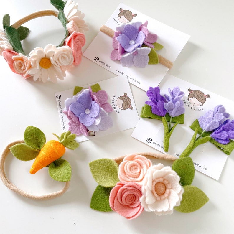 May include: A set of felt flower headbands for girls. The headbands feature a variety of flowers, including daisies, roses, and hydrangeas. The headbands are perfect for adding a touch of whimsy to any outfit.