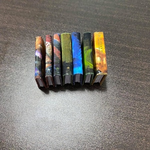 May include: A set of seven miniature hardcover books with colorful covers. The books are arranged in a row, with the spines facing the viewer. The titles of the books are visible, including "Harry Potter and the Goblet of Fire".