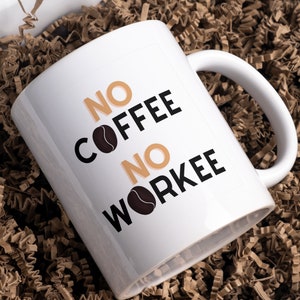 May include: White ceramic coffee mug with black text that reads "NO COFFEE NO WORKEE" with a coffee bean graphic.