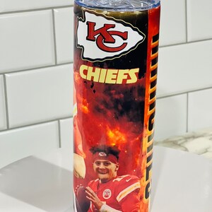 Może przedstawiać: Kubek ze stali nierdzewnej z czerwono-czarno-ż&oacute;łtym wzorem przedstawiającym logo Kansas City Chiefs i wizerunek gracza. Kubek ma przezroczystą pokrywkę.