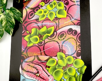 May include: A pink and yellow snake with black markings is curled around green leaves. The snake has a light blue background and is surrounded by a black border.