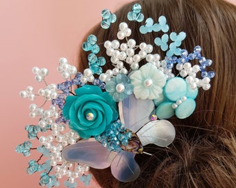 May include: A blue and white hair comb with a butterfly design, featuring pearl beads, blue crystals, and a turquoise flower.