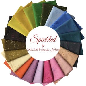 May include: A collection of 20 fabric squares in various colors with a speckled pattern. The fabric squares are arranged in a circle with the text "Speckled by Rashida Coleman-Hale" in the center.