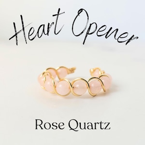 May include: A gold wire ring with pink rose quartz beads. The ring is called "Heart Opener".