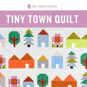 May include: A colorful quilt with a repeating pattern of geometric houses, trees, and flowers. The quilt features a white background with a quilted design. The text "TINY TOWN QUILT" is displayed at the top. The quilt is made by Pen + Paper Patterns.