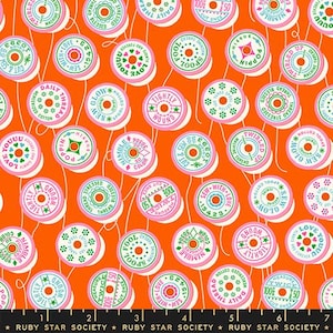 May include: Orange fabric with a repeating pattern of pink and green thread spools. Each spool has text such as "Love You" and "Sew With Love". The words "Ruby Star Society" are at the bottom.