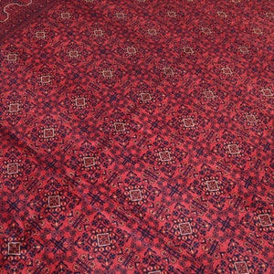 May include: A red rug with a repeating pattern of blue and white geometric shapes. The rug has a traditional Persian design.