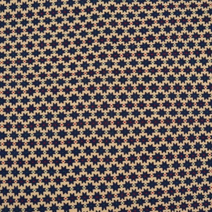 May include: A beige fabric with a repeating pattern of dark blue stars with red and green accents.