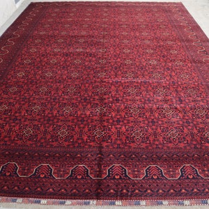 May include: A red and blue patterned rug with a detailed border. The rug has a traditional design and is made of wool.