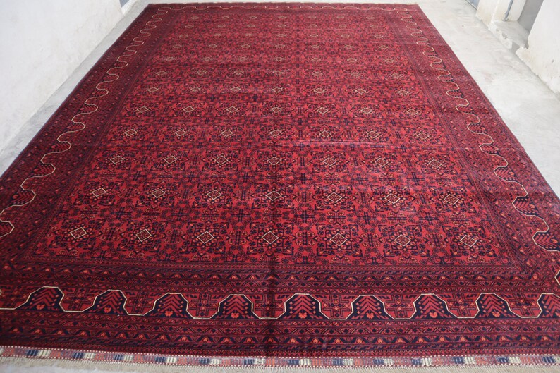 May include: A red and blue patterned rug with a detailed border. The rug has a traditional design and is made of wool.