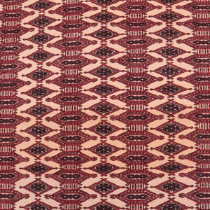 May include: A beige rug with a repeating geometric pattern in shades of red and black. The pattern features diamond shapes with intricate details.