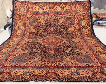 May include: A large, intricately patterned rug with a deep blue background and a central medallion in shades of red, gold, and blue. The rug features a floral and geometric design with intricate details.