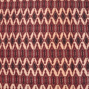 May include: A close-up of a red, black and white patterned fabric with a repeating diamond design.