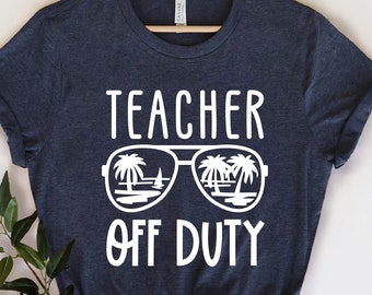 May include: A dark blue t-shirt with white text that reads "Teacher Off Duty" and a graphic of sunglasses with palm trees reflected in the lenses.