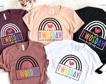May include: Five t-shirts with a rainbow and heart design. The text on the shirts reads "Happy Twosday 2-22-22". The shirts are in various colors, including maroon, peach, black, brown, and white.