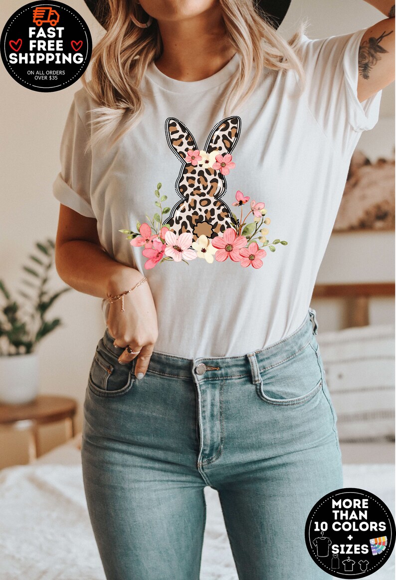 May include: White t-shirt with a graphic of a leopard print bunny with pink flowers. The shirt is available in more than 10 colors and sizes.