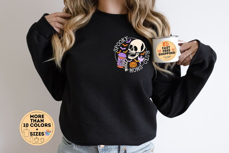 May include: Black sweatshirt with a graphic of a skeleton drinking coffee and the text "Spooky Moms Club". The sweatshirt is available in multiple colors and sizes.