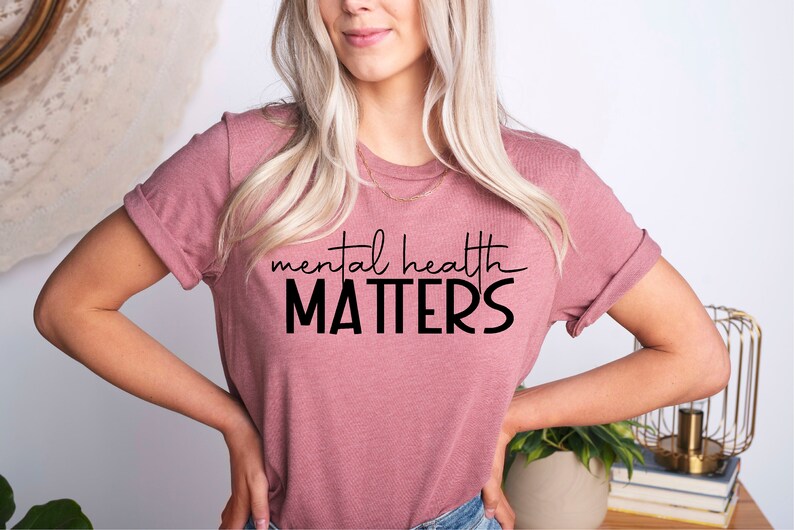 May include: A mauve t-shirt with the text "mental health MATTERS" in black lettering.