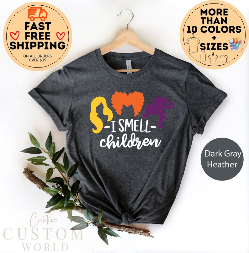 May include: Dark gray heather t-shirt with a graphic of three witches with the text "I Smell Children".
