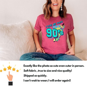 May include: A maroon t-shirt with the text "TAKE ME BACK TO THE 90'S" in teal, yellow, and pink. The graphic includes a boombox, roller skates, and a leopard print design. The shirt is worn by a person.