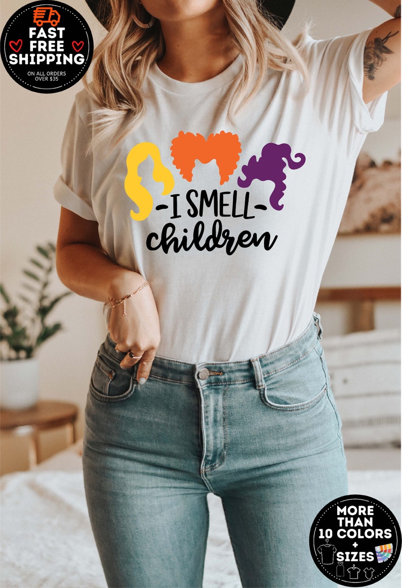 May include: White t-shirt with a graphic of three witches' silhouettes and the text "I smell children".
