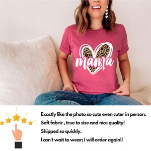 May include: Pink t-shirt with a white heart design featuring a leopard print. The text "mama" is written in white inside the heart.